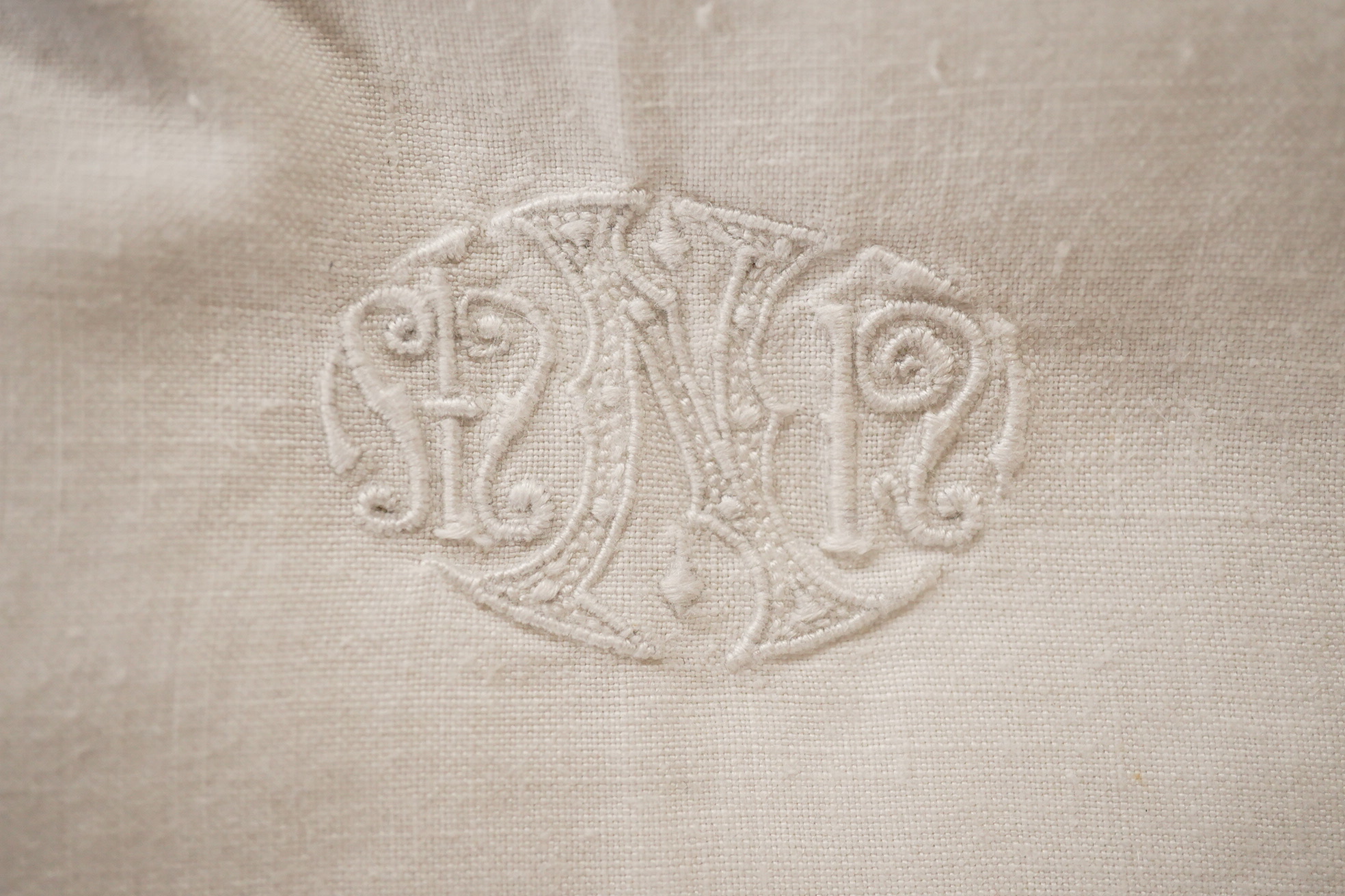 Two matching linen hand monogrammed sheets, one 216cm x 330cms, the other 212cm x 340 cms, together with three later monogrammed linen pillow cases and three embroidered cotton pillowcases.